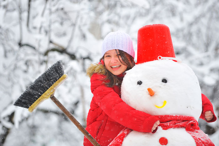 girl hugging snowman