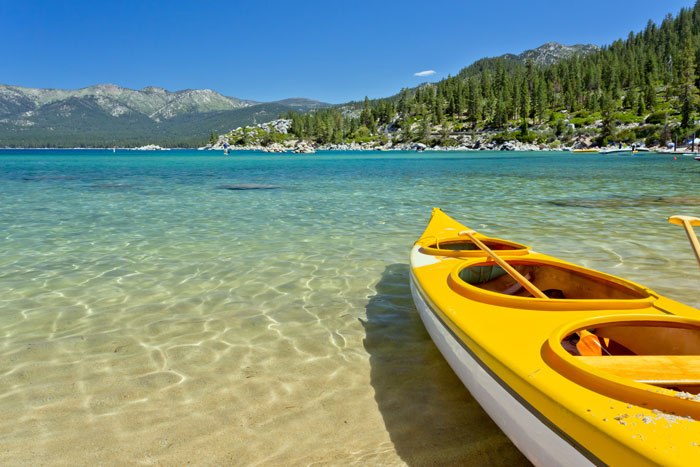 kayak beached at edge of mountain lake